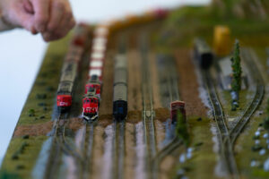 4 miniature model trains on a track.