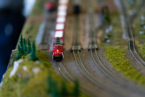 A close-up of a red miniature train on a train track.